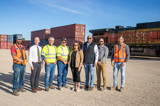 The 1,000th BNSF train that RMG loaded; from left to right: Conductor Michael Berman; Minot Area Chamber EDC Mark Lyman; RMG CEO Greg Oberting; RMG General Manager Chris Rehder; Minot Area Chamber EDC CEO Brekka Kramer; BNSF Supt. of Operations Dave McCann; BNSF Terminal Manager (Minot) Andrew Sprague; and BNSF Terminal Trainmaster (Minot) Sam Huff. 